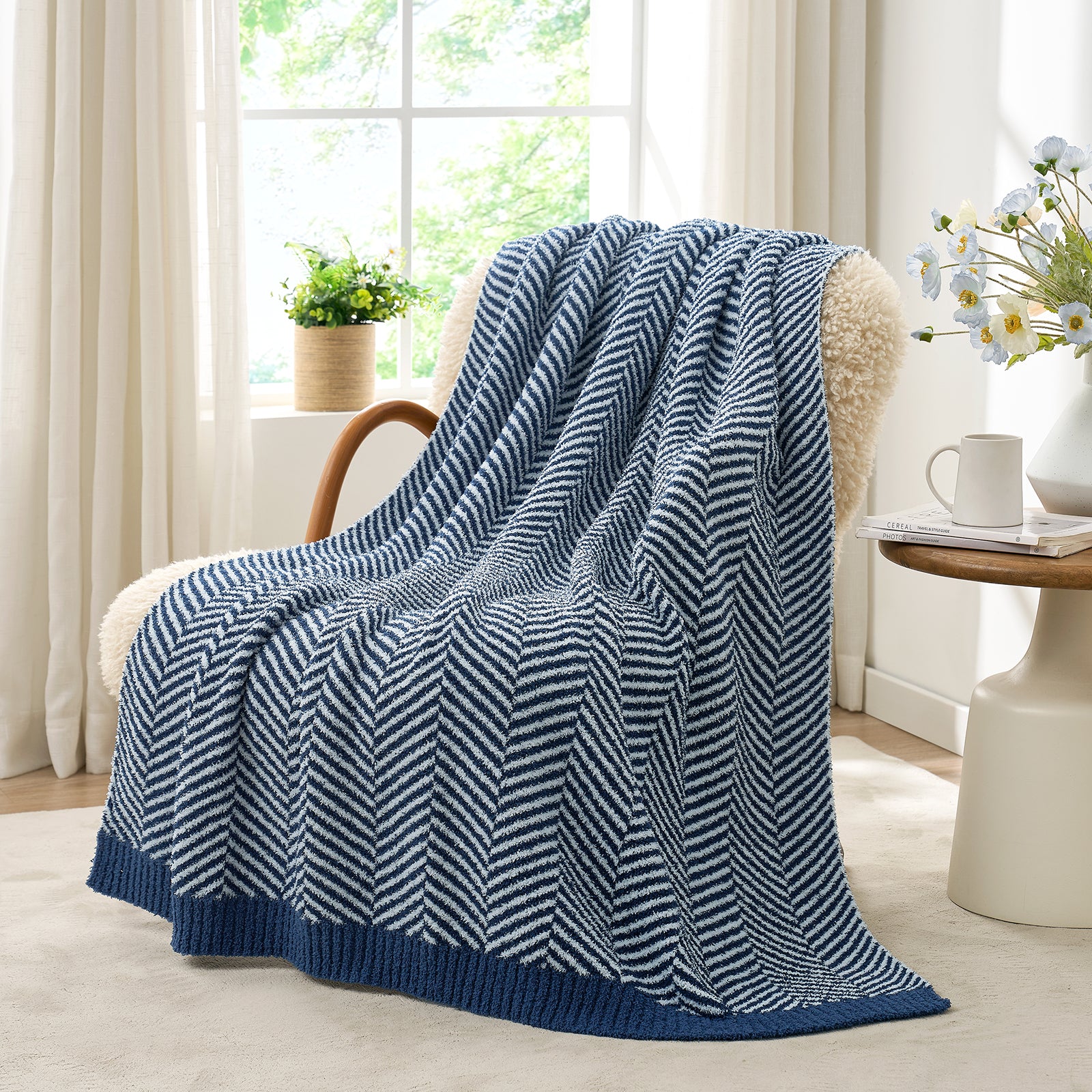 Snuggle Sacs Herringbone Feather Yarn Knit Throw Blanket on the chair with window and plant behind#color_Navy