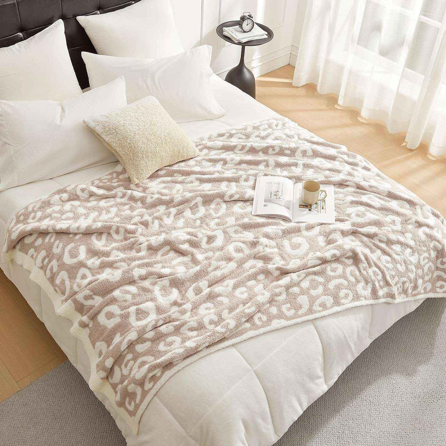 Reversible Leopard Feather Yarn Knit Throw Blanket on a bed with a mug and magazine in a bright room#Color_Leopard Beige