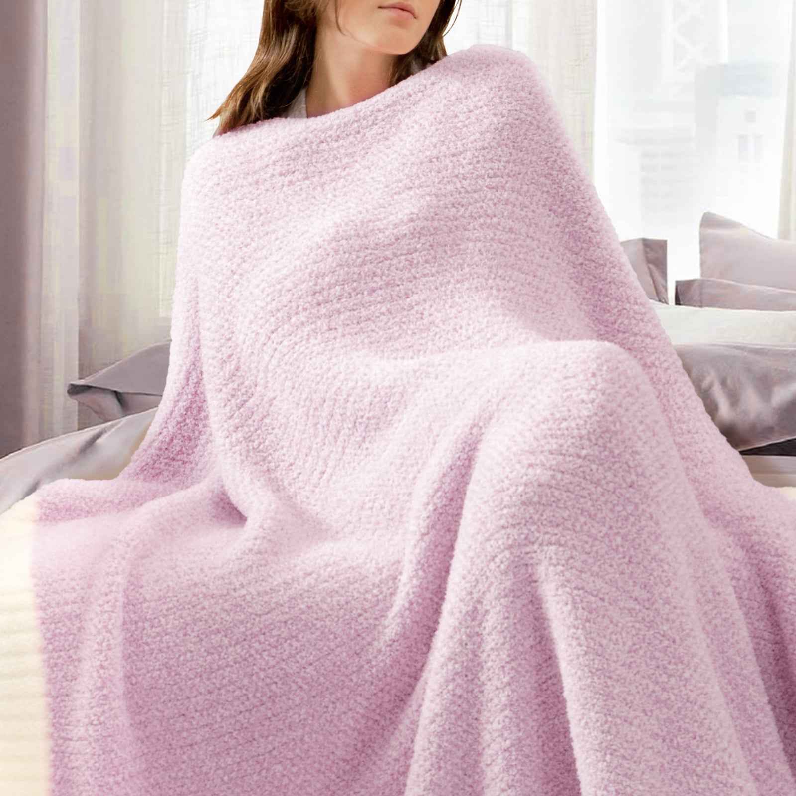 A woman wrapped in Snuggle Sac Heather Feather Yarn Lilac Knit Throw Blanket #Color_Lilac