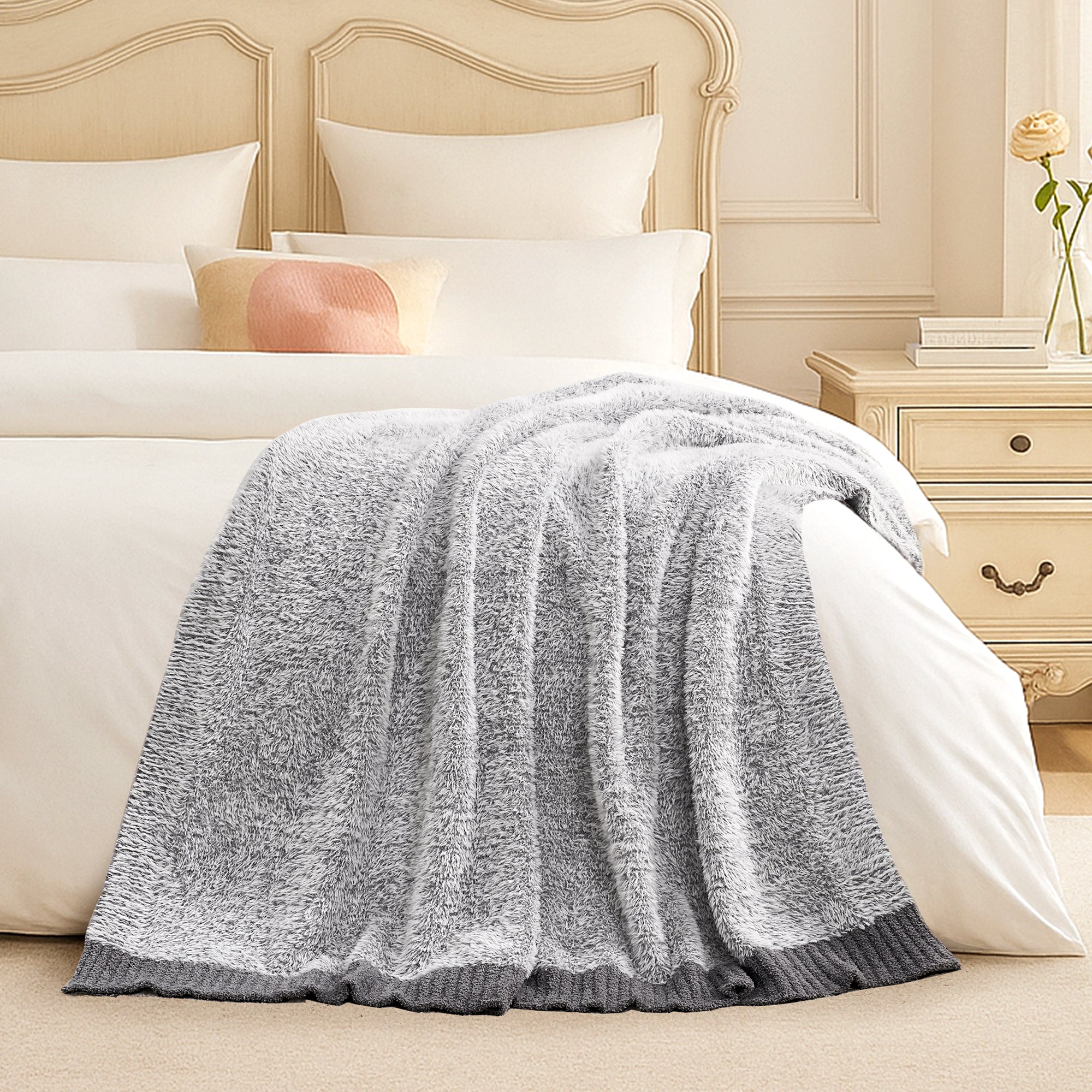 Snuggle Sac ultrasoft faux fur knit throw blanket in Gray layered on a bed, creating a soft and inviting bedroom look #color_Gray