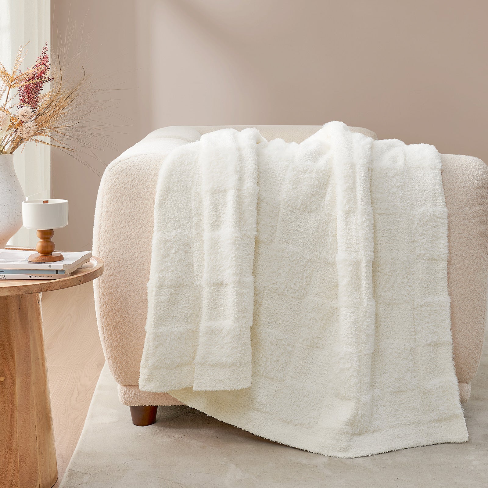UltraCozy Solid Checkered Feather Yarn Knit Throw Blanket on a beige couch - #Color_Solid Ivory