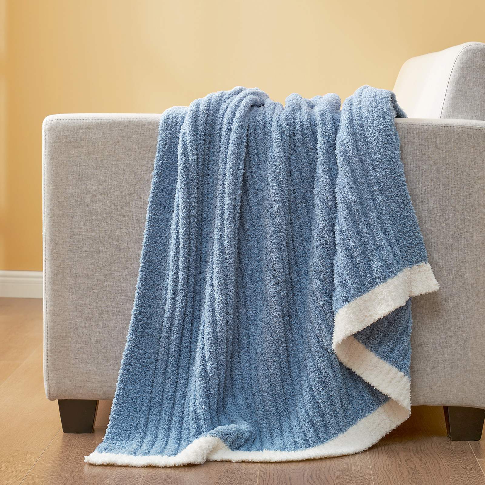 Snuggle Sac UltraSoft Ribbed Feather Yarn Knit Throw Blanket draped on the sofa#Color_Blue