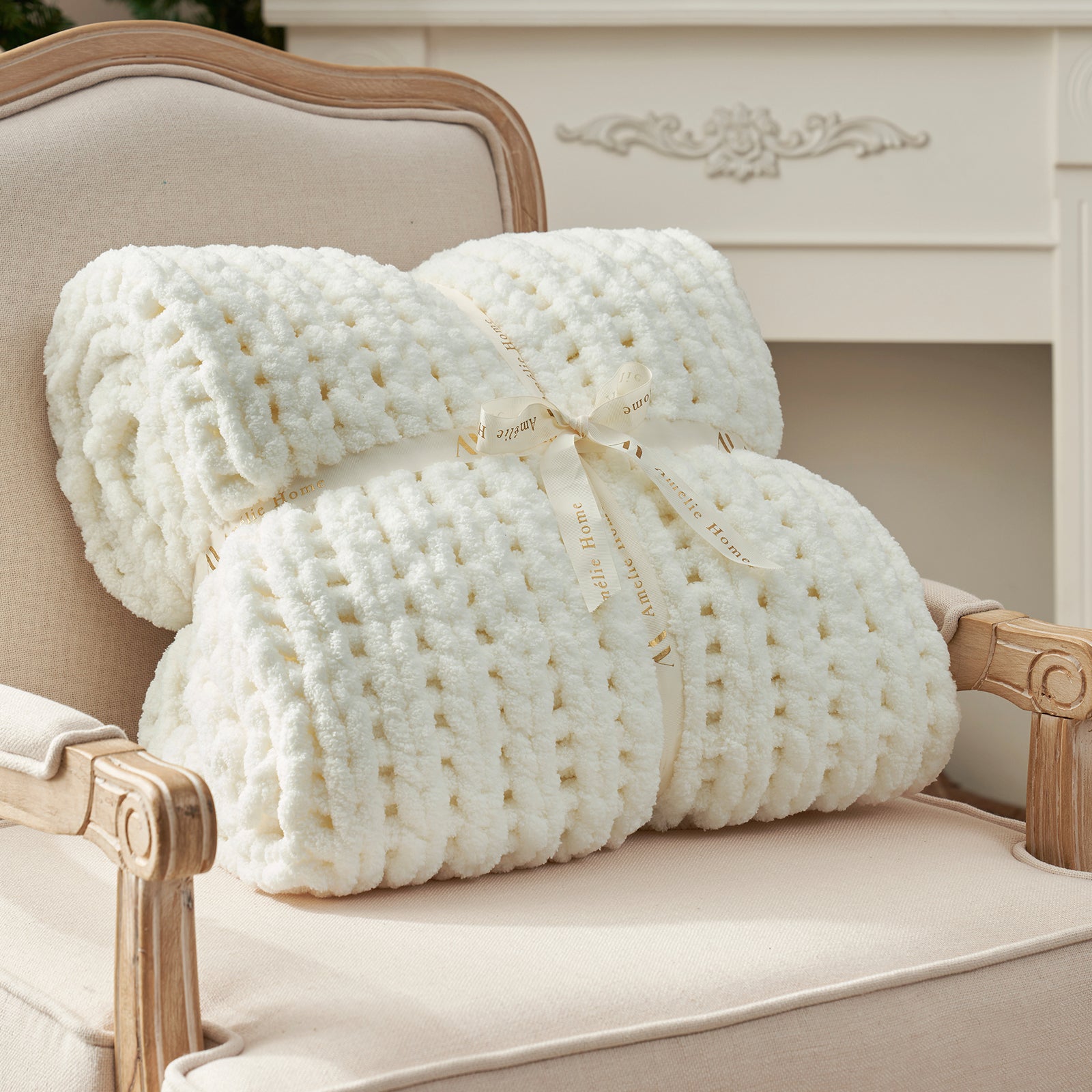 Rolled chunky knit throw blanket in Ivory with ribbon showcasing plush texture #color_Ivory
