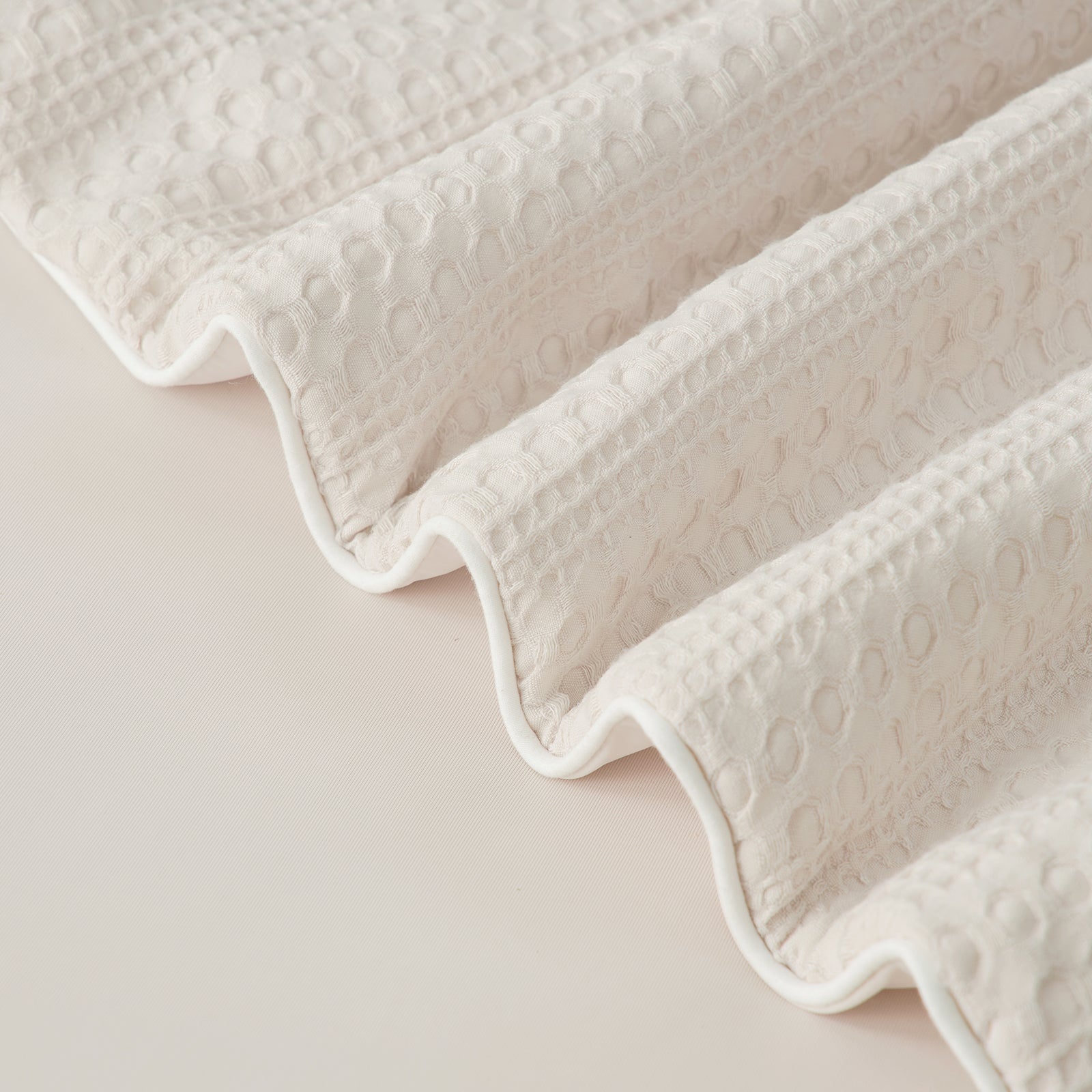 close up of  Snuggle Sac Natural Fiber Waffle Cooling Comforter edges #color_Beige