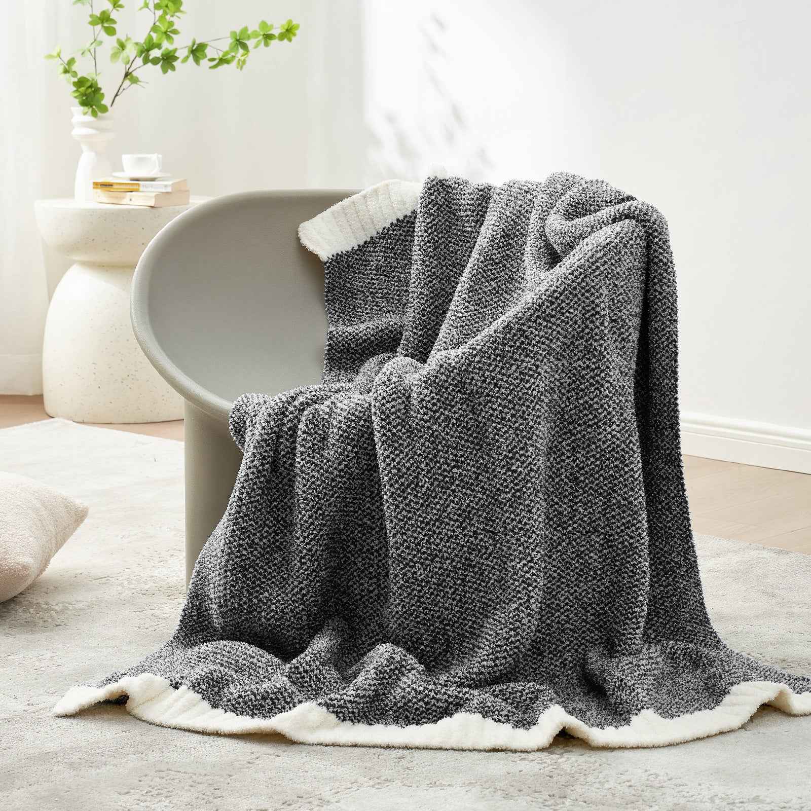 Snuggle Sac Heather Feather Yarn Black Knit Throw Blanket  on the chair#Color_Black